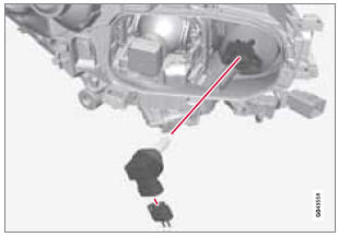 1. Remove the headlight housing from the vehicle (see page 306).